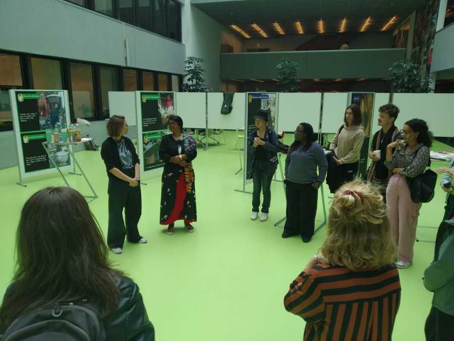 Deborah Freeman from Informal Economy Workers' Forum (INFORUM) Ghana gives a tour of the exhibition to ETH students.